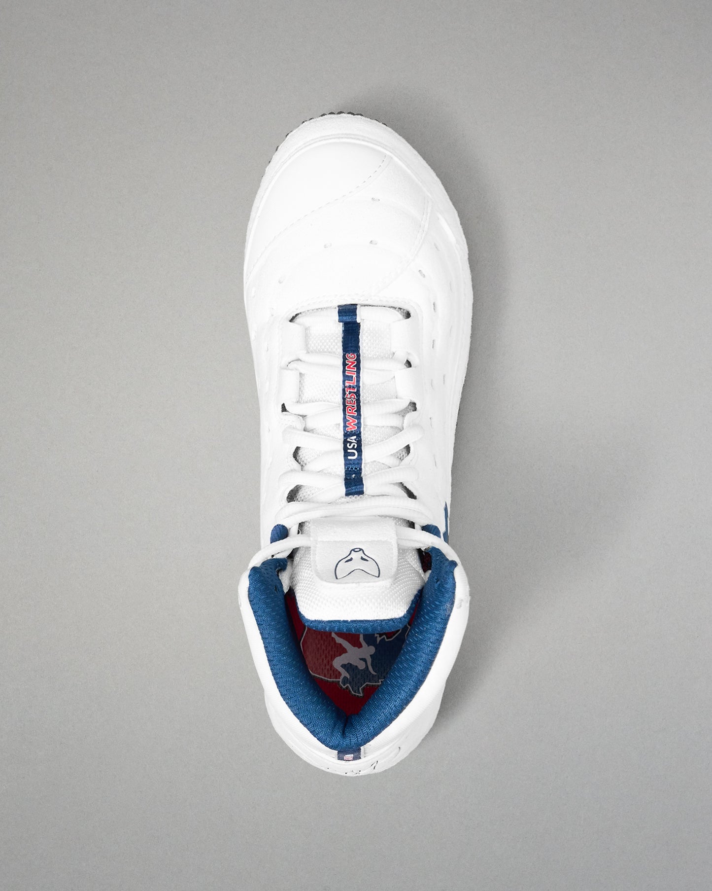 White wrestling shoe with blue lining on a gray background