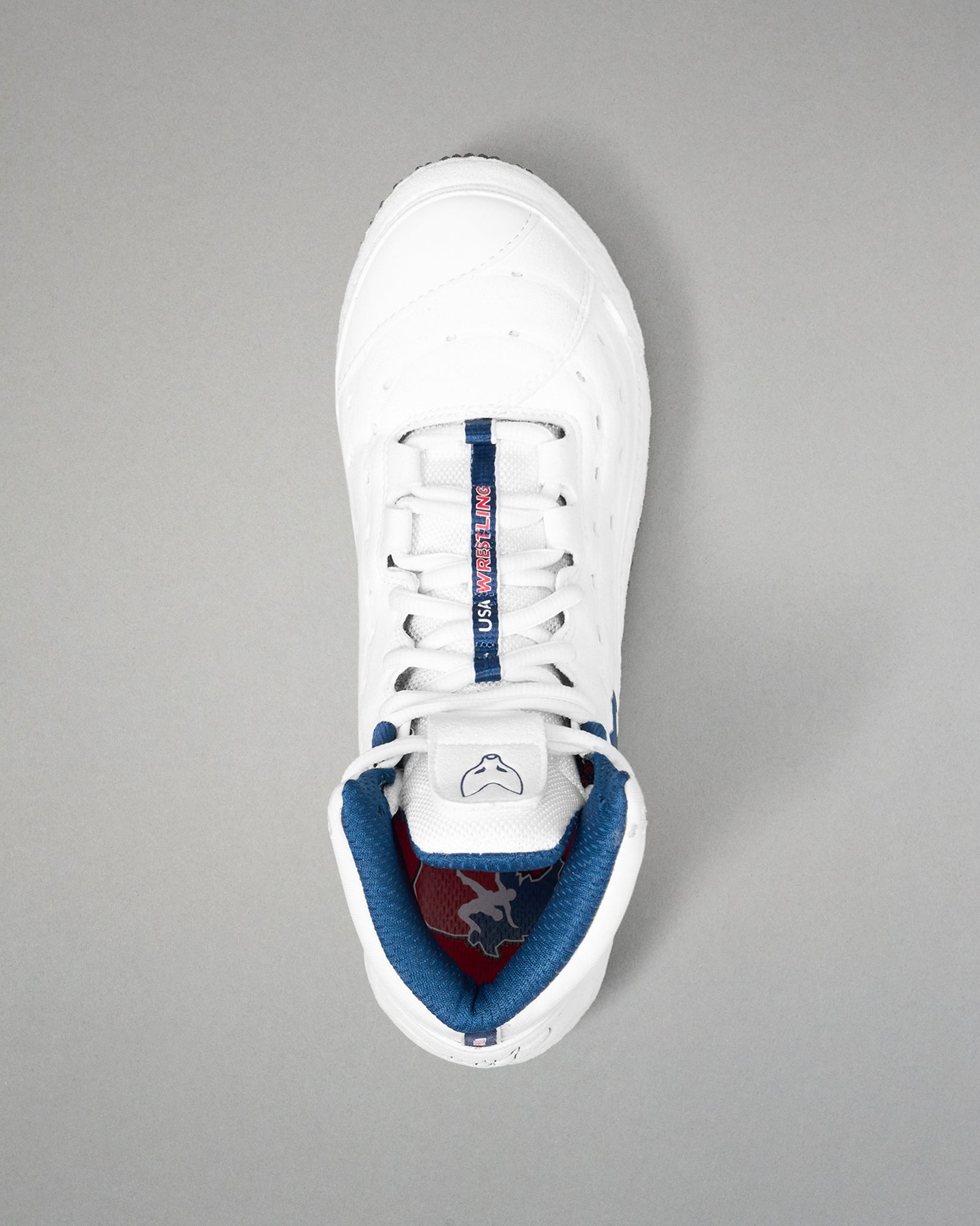 White wrestling shoe with blue lining on a gray background