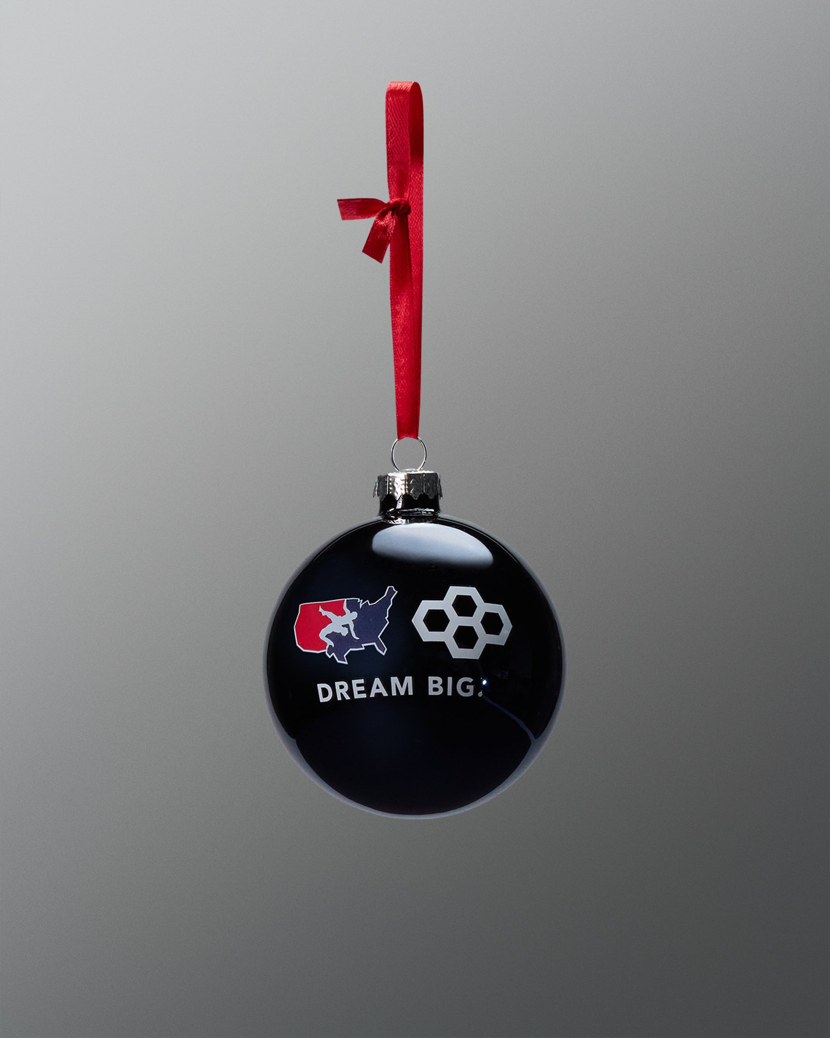 Black ornament with red, white, and blue design and 'Dream Big' text on a gray background