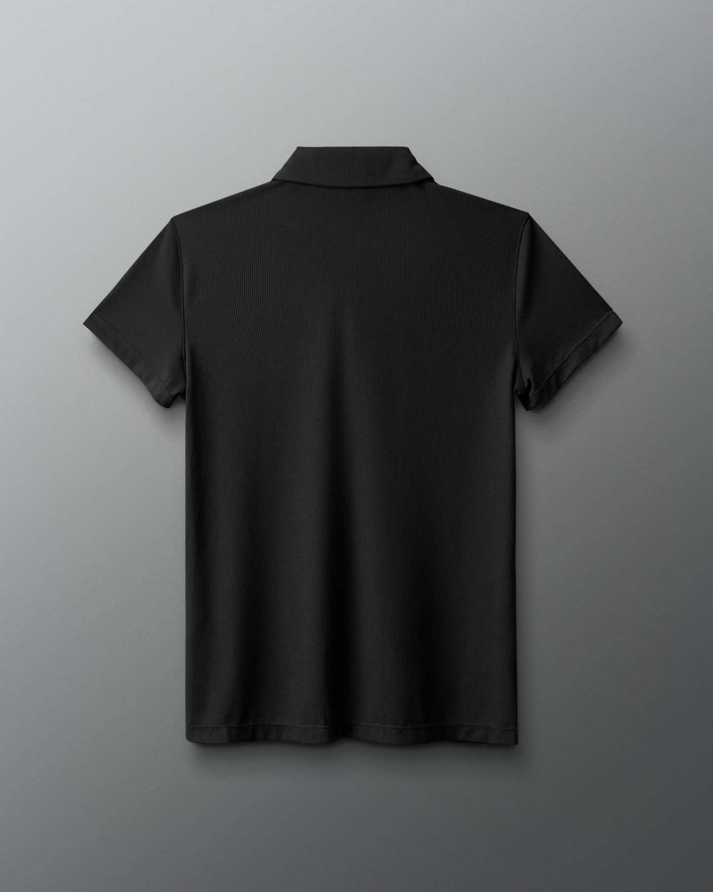 Black polo shirt on a gray background