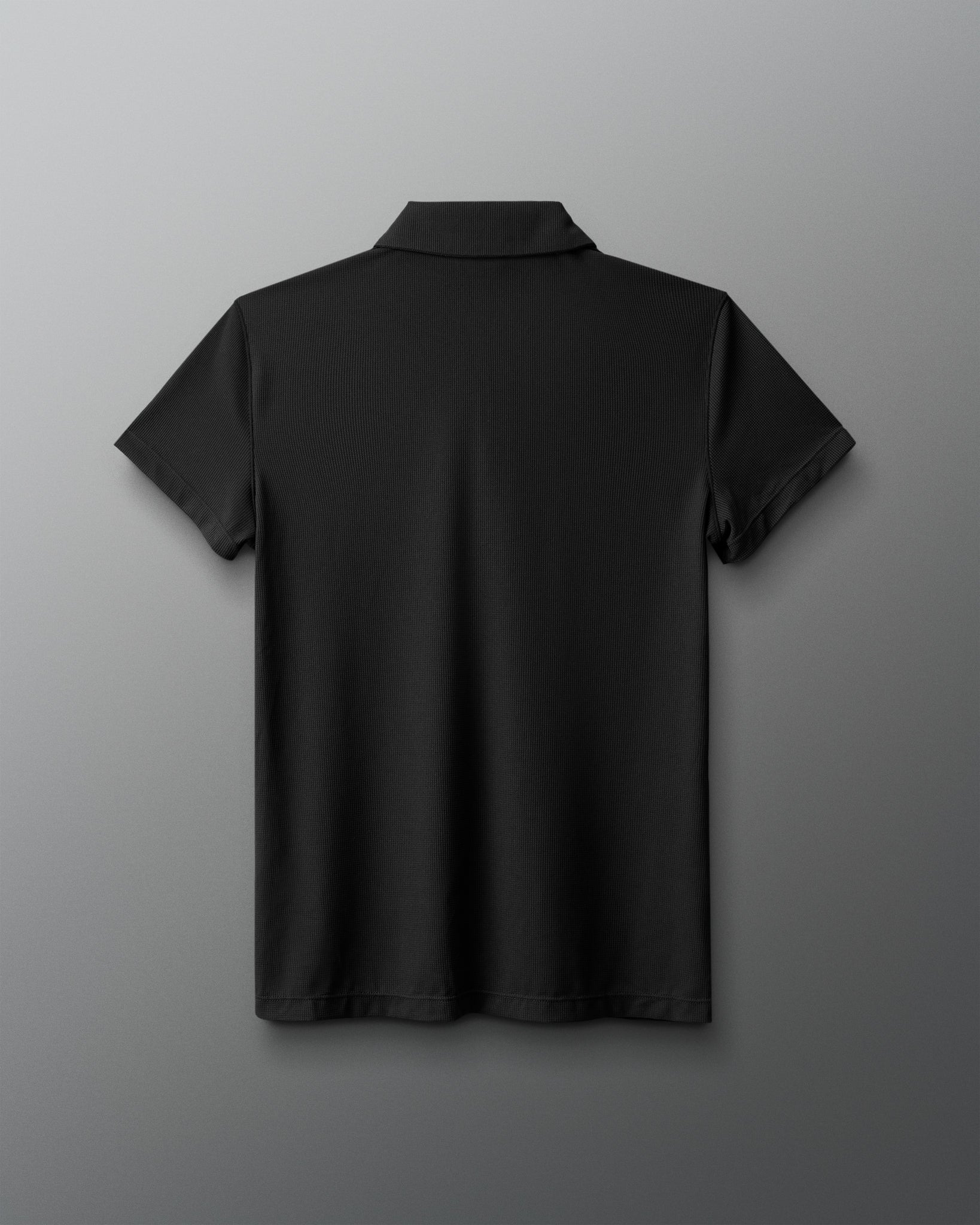 Black polo shirt on a gray background