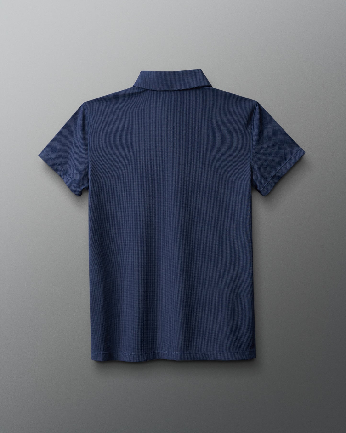Navy blue polo shirt on a gray background