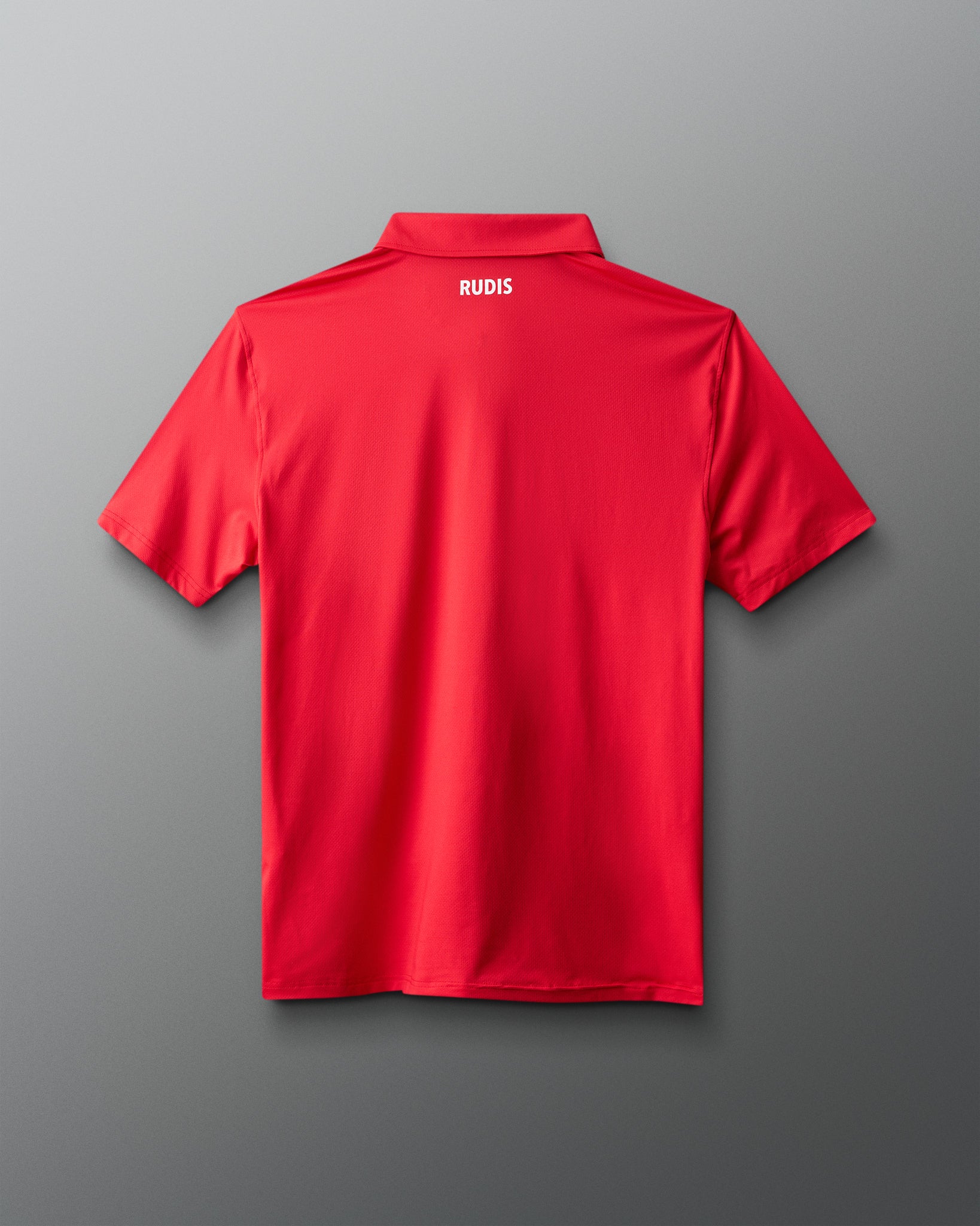 Red polo shirt with 'RUDIS' branding on the back against a gray background