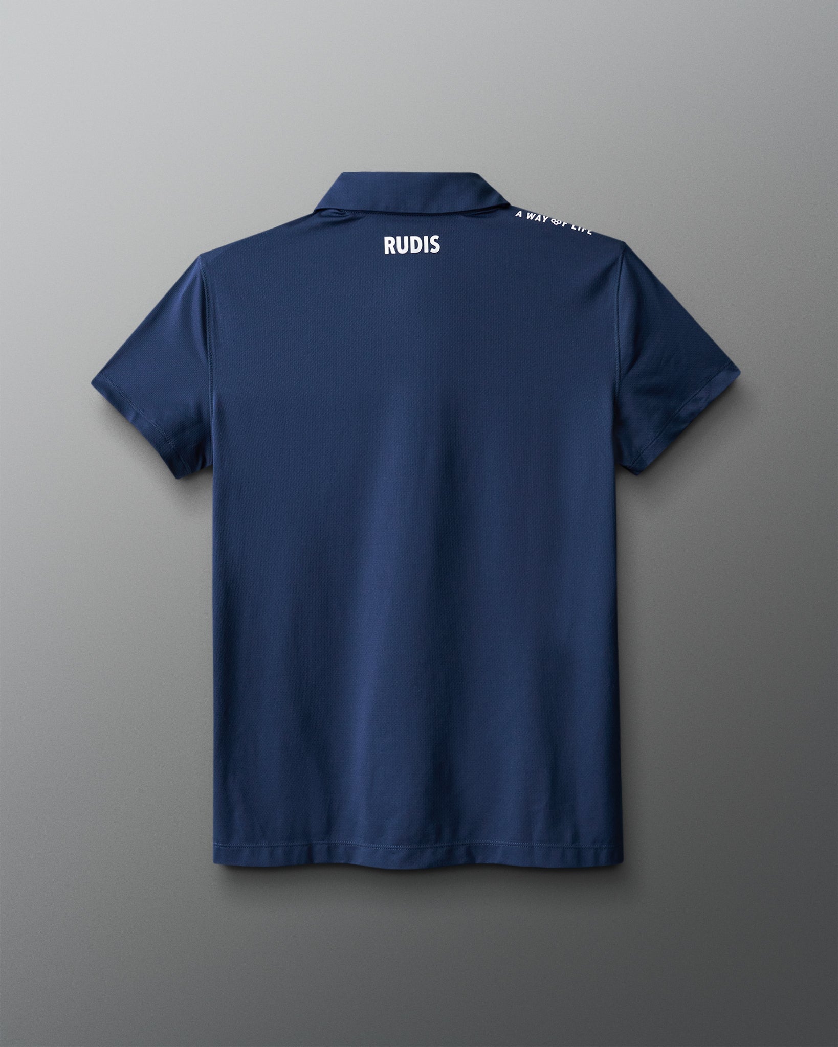 Blue polo shirt with 'RUDIS' branding on the back against a gray background