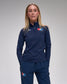 Person wearing a navy tracksuit with 'USA Wrestling' and 'RUDIS' logos on a gray background