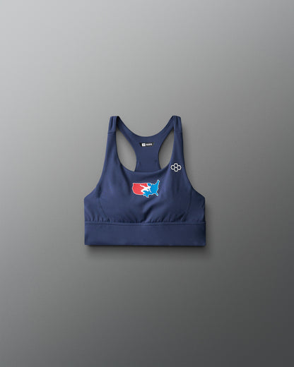 Navy blue sports bra with a logo on a gray background