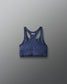 Blue sports bra with 'RUDIS' branding on a gray background