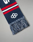 Navy blue scarf with red and white stripes and a geometric pattern on a gray background