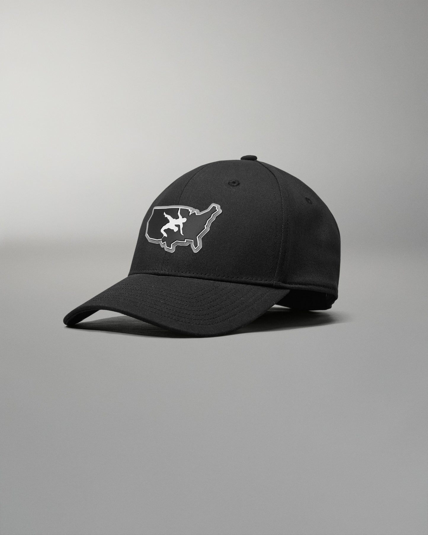Black cap with a white USA Wrestling logo on a gray background