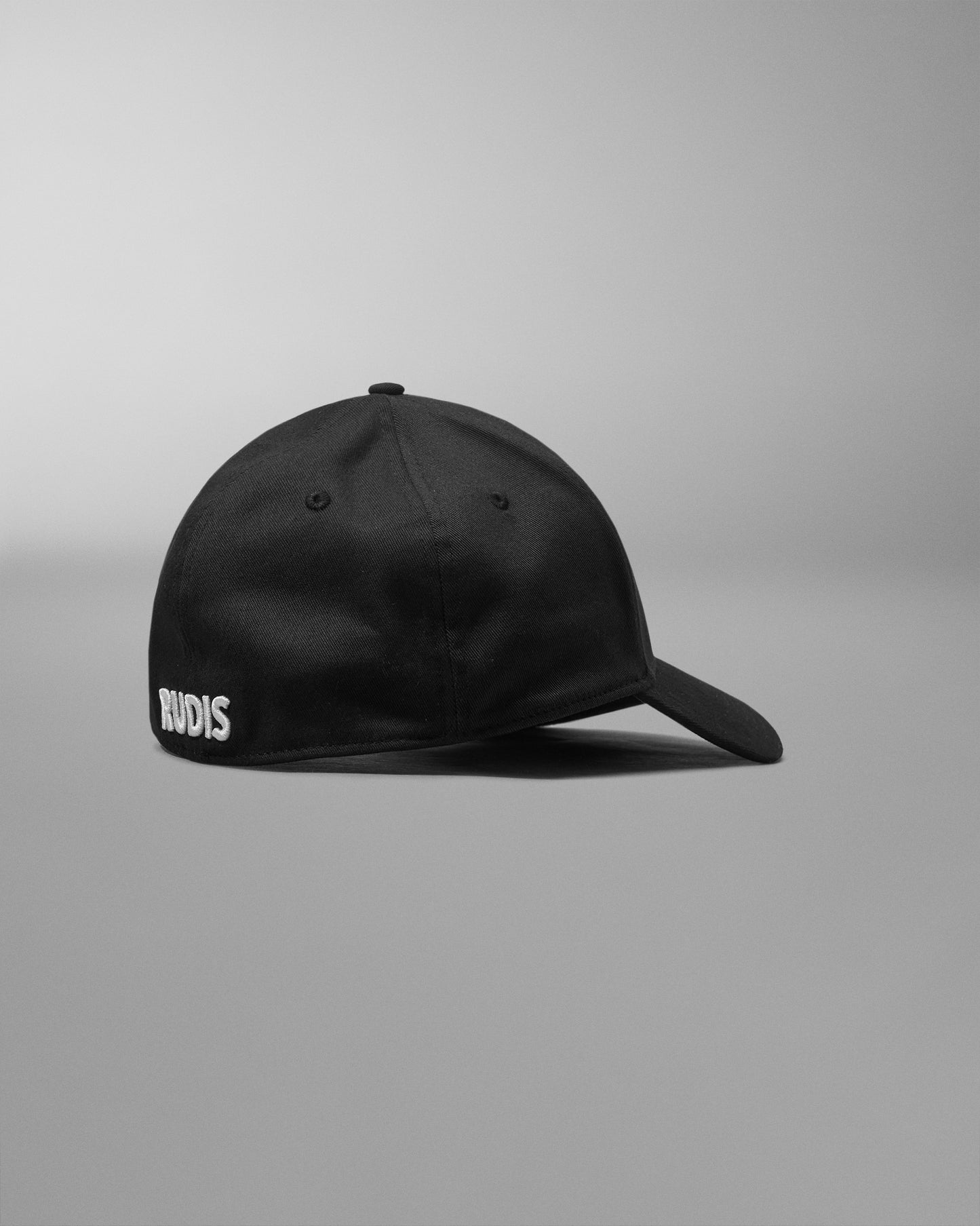 Black cap with 'RUDIS' logo on a gray background