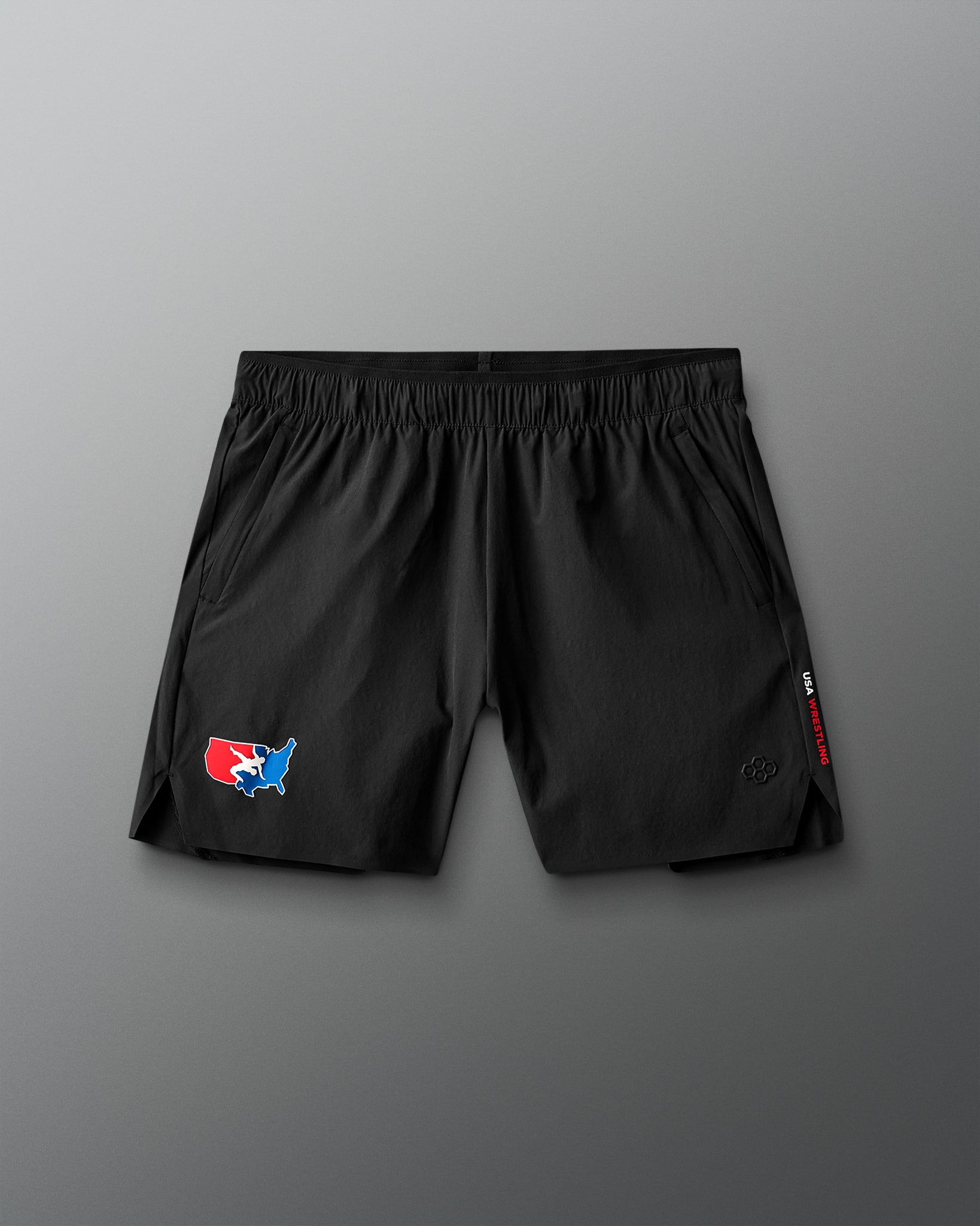 Black shorts with a USA Wrestling logo on a gray background