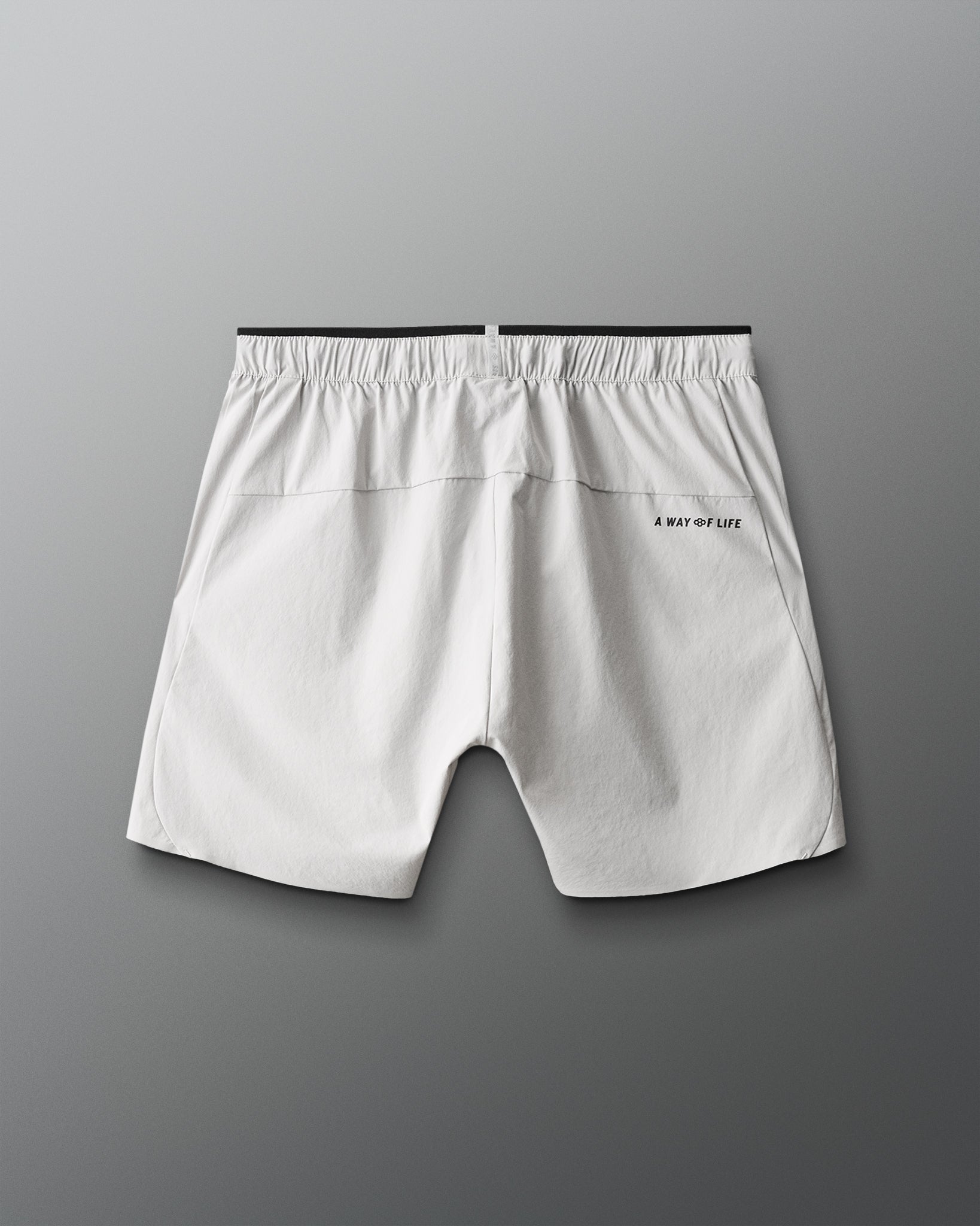 Light gray shorts with a brand logo on a gray background