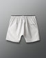 Light gray shorts with a brand logo on a gray background