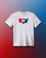 A white short-sleeve athletic T-shirt is displayed against a red-to-blue gradient background. Centered on the chest is a red, white, and blue USA Wrestling logo in the shape of the continental U.S., featuring two wrestlers in action. The shirt has a modern athletic fit.