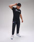 Person wearing a black 'USA Wrestling' t-shirt and pants on a gray background