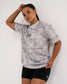 Female model wearing the USA Wrestling Map Classic Cotton T-Shirt in light gray tree camo, featuring a gray wrestling silhouette inside a USA map outline, paired with black athletic shorts.