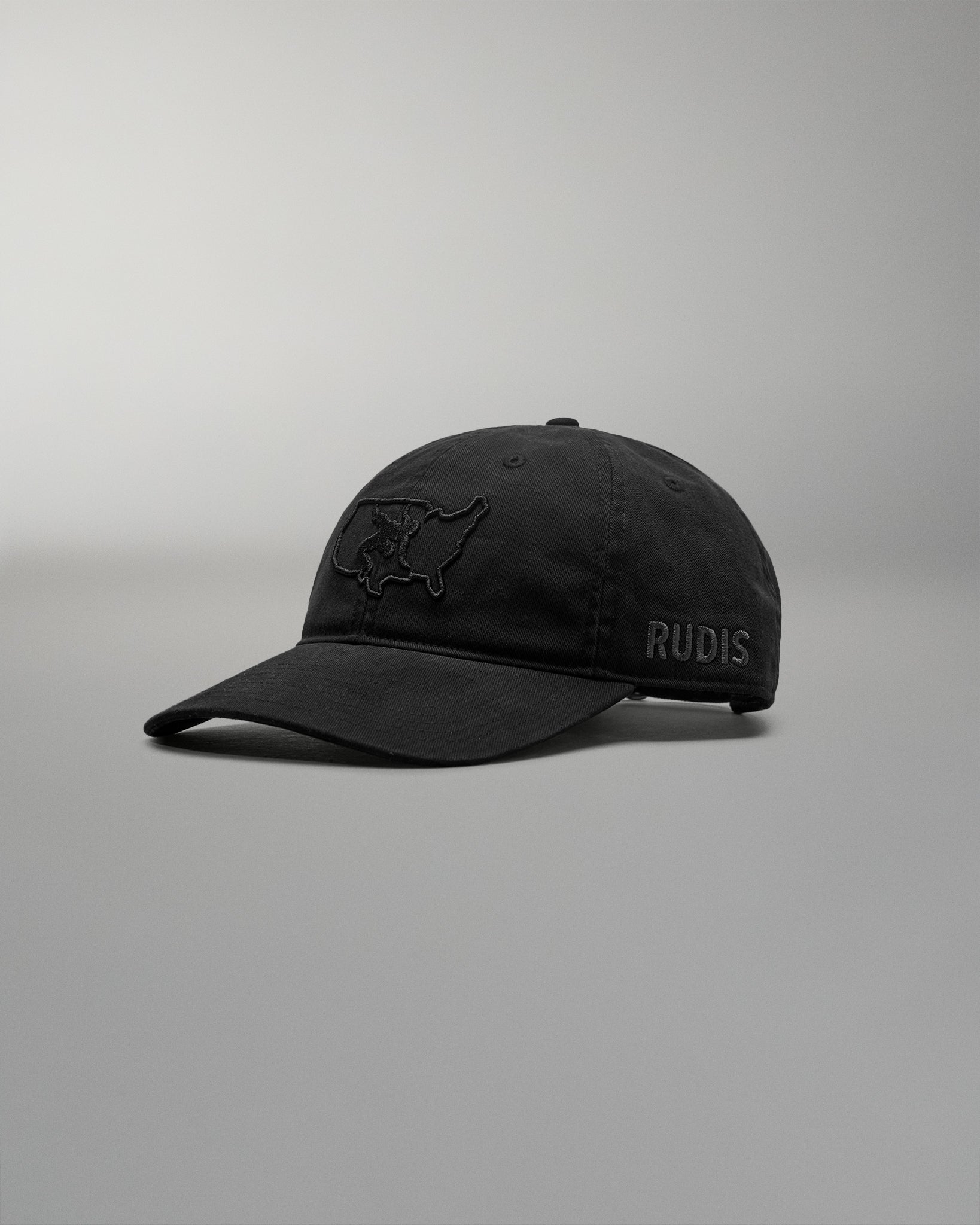 Black cap with 'RUDIS' logo on a gray background