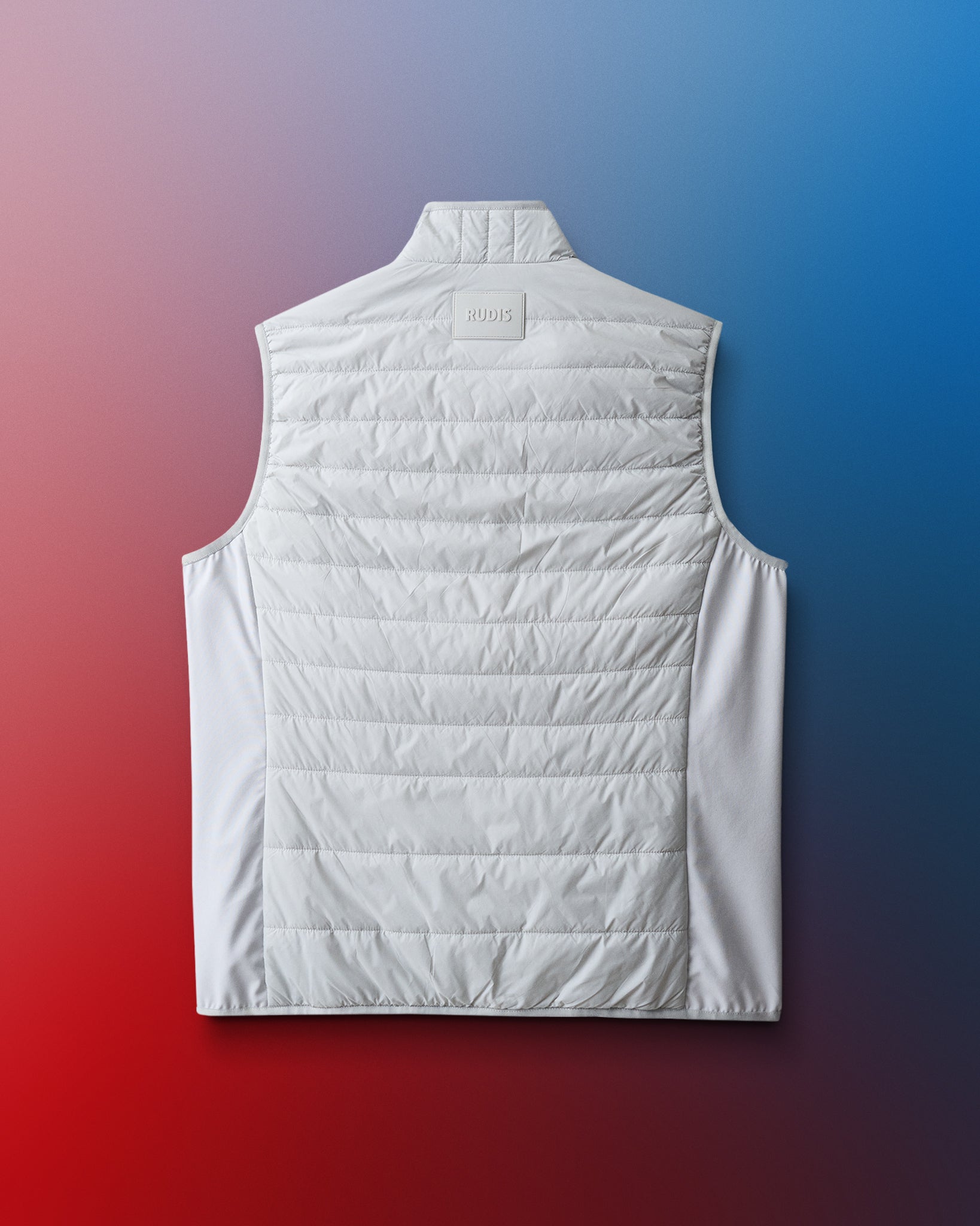 White puffer vest on a gradient blue to red background