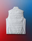 White puffer vest on a gradient blue to red background