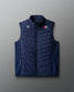 Navy blue puffer vest with logos on a gradient background