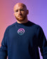 Man wearing a blue sweatshirt with a logo on a gradient background