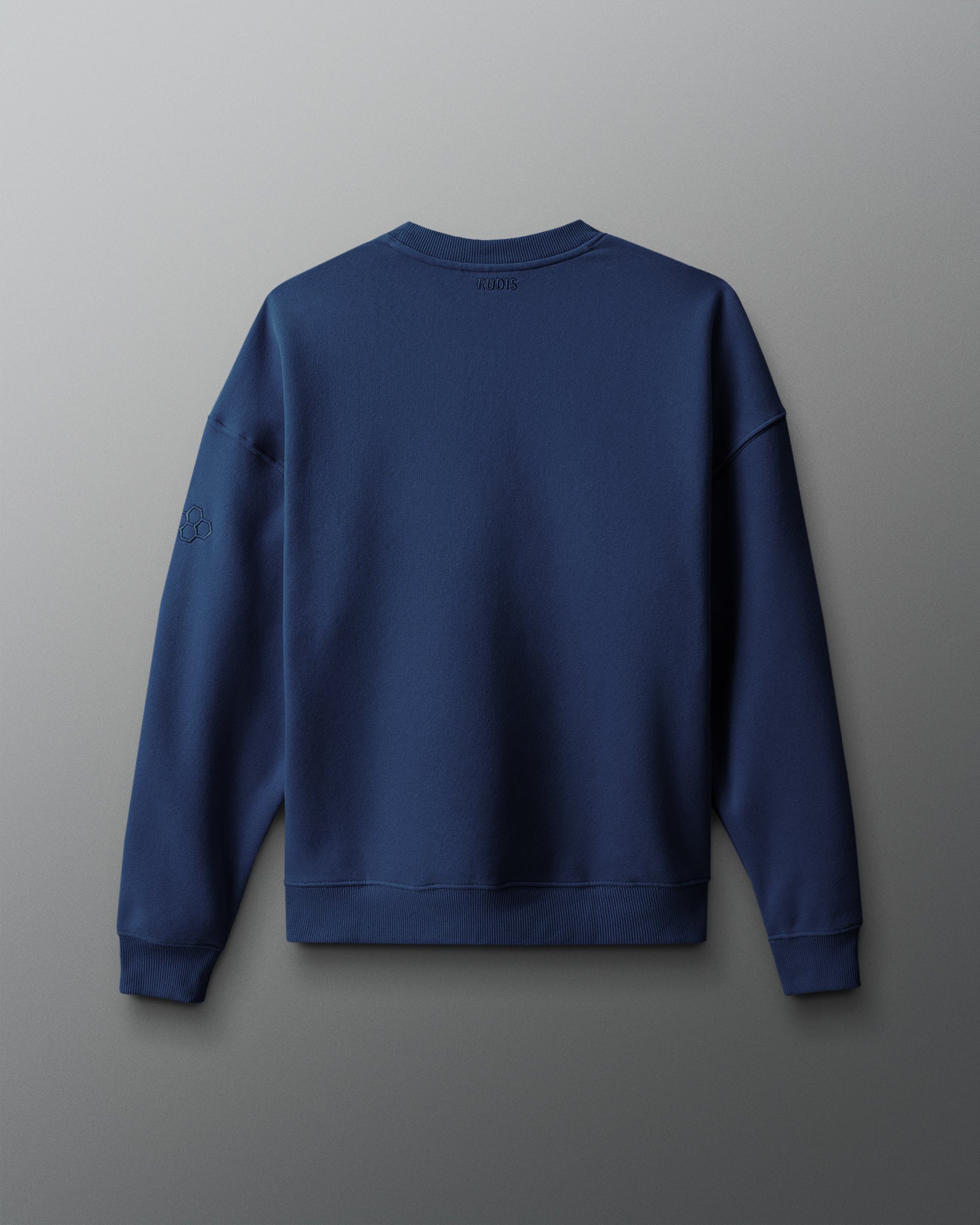 Back view of the navy RUDIS UWW Globe Relaxed Comfort Fleece Crewneck, featuring a clean tonal design with subtle RUDIS branding below the back neckline and a tonal RUDIS mark on the sleeve.
