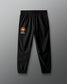 Black sweatpants with a logo on a gray background