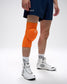 Person wearing an orange knee pad on a white background