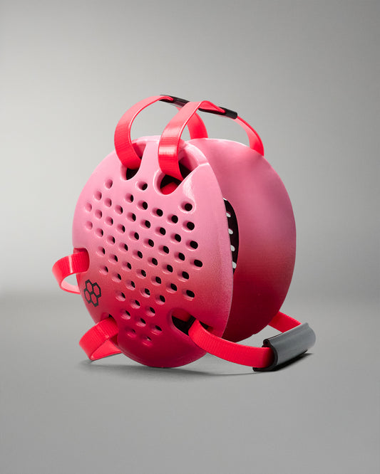 Pink and red headgear with a textured surface on a gray background