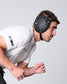 Person wearing a black protective headgear against a gray background