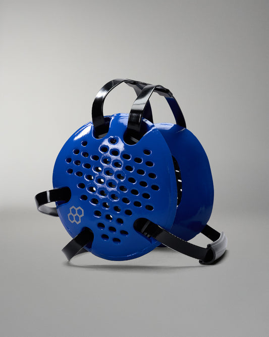 Blue headgear with black straps on a gray background