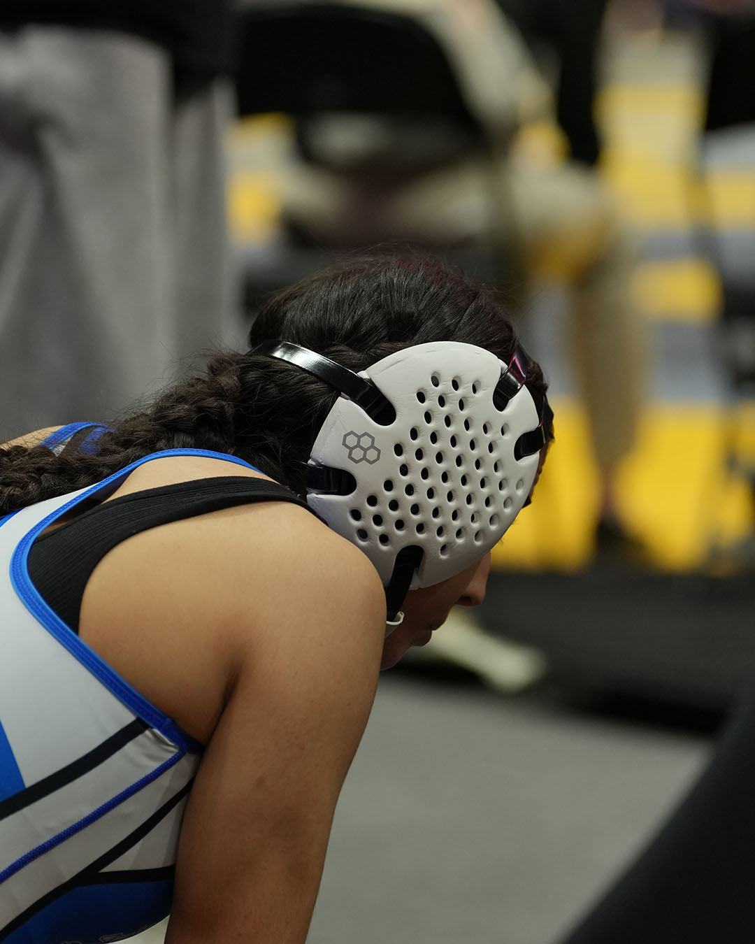 Person wearing a wrestling headgear in an indoor setting