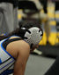 Person wearing a wrestling headgear in an indoor setting