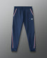 Navy blue jogger pants with white and red stripes on a gray background