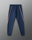 Navy blue jogger pants with red and white stripes on a gray background