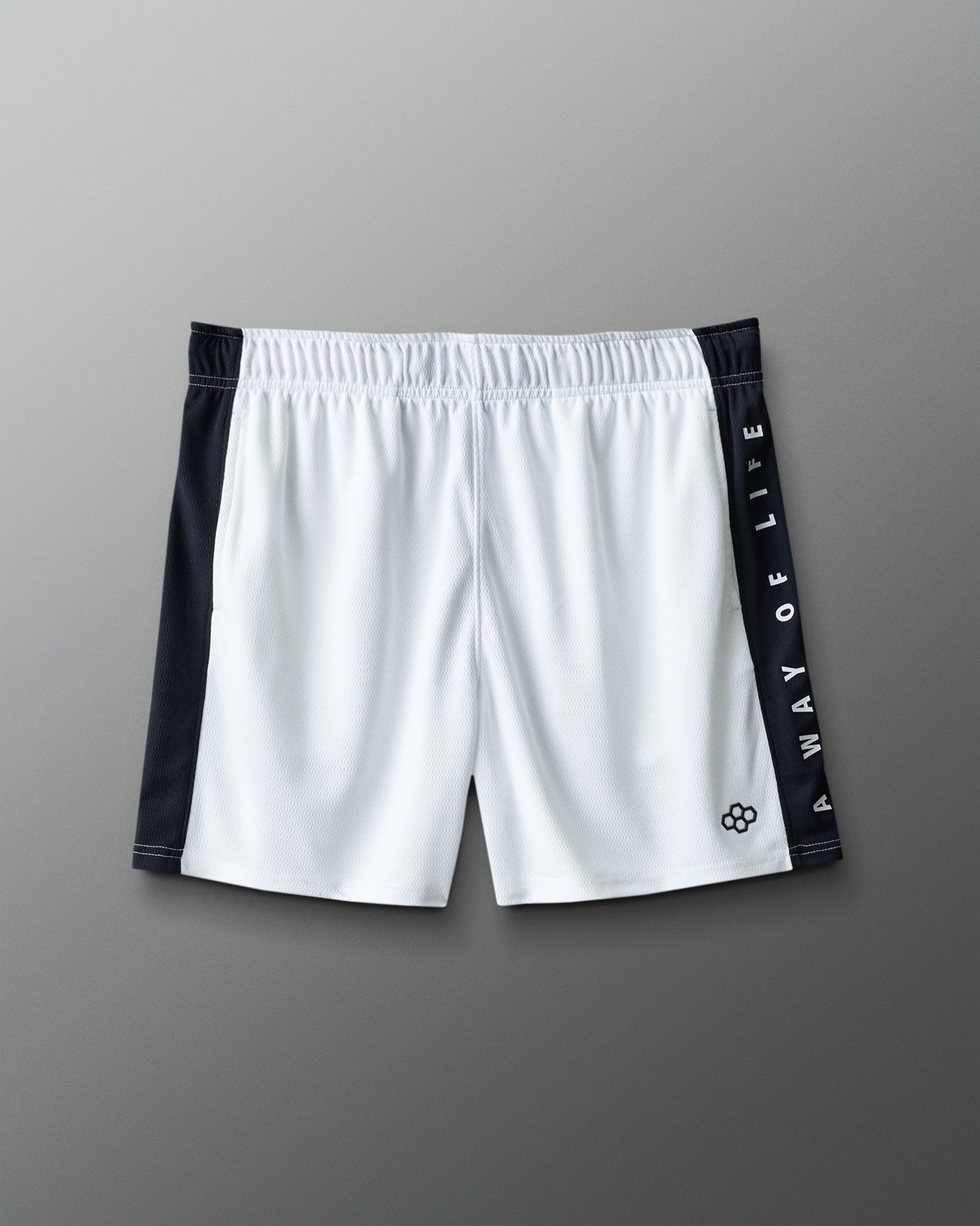 White shorts with black side panels and branding on a gray background