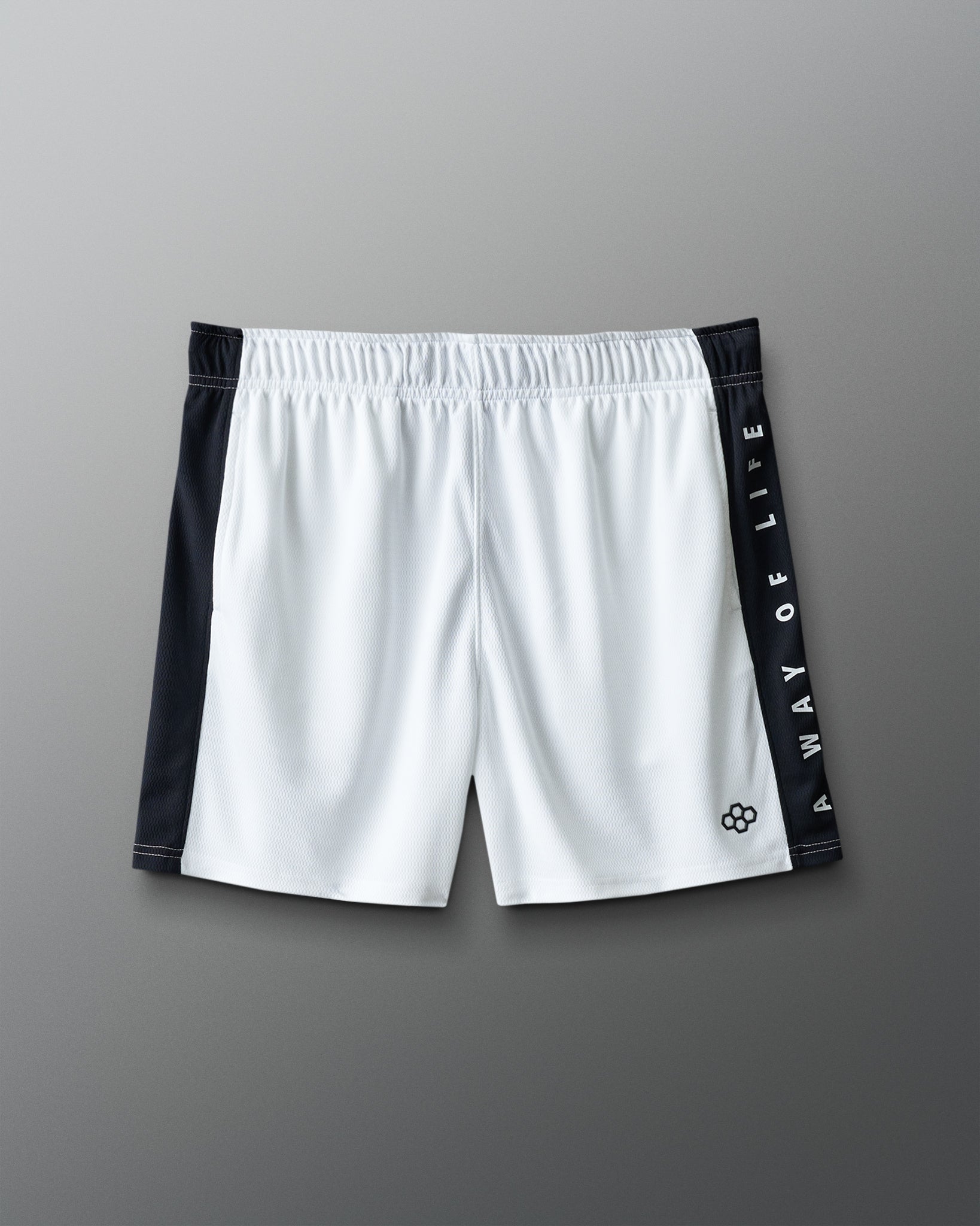 White shorts with black side panels and branding on a gray background