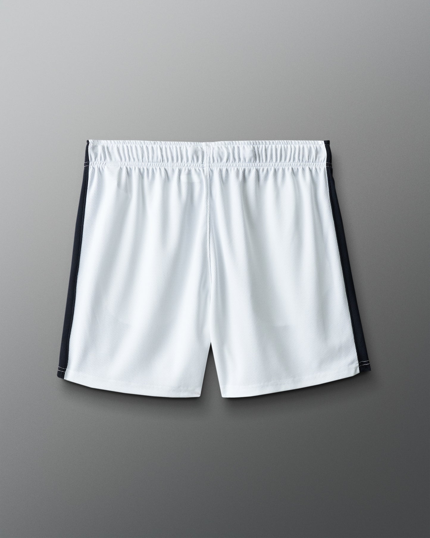 White shorts with black accents on a gray background