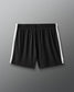 Black shorts with white stripes on a gray background