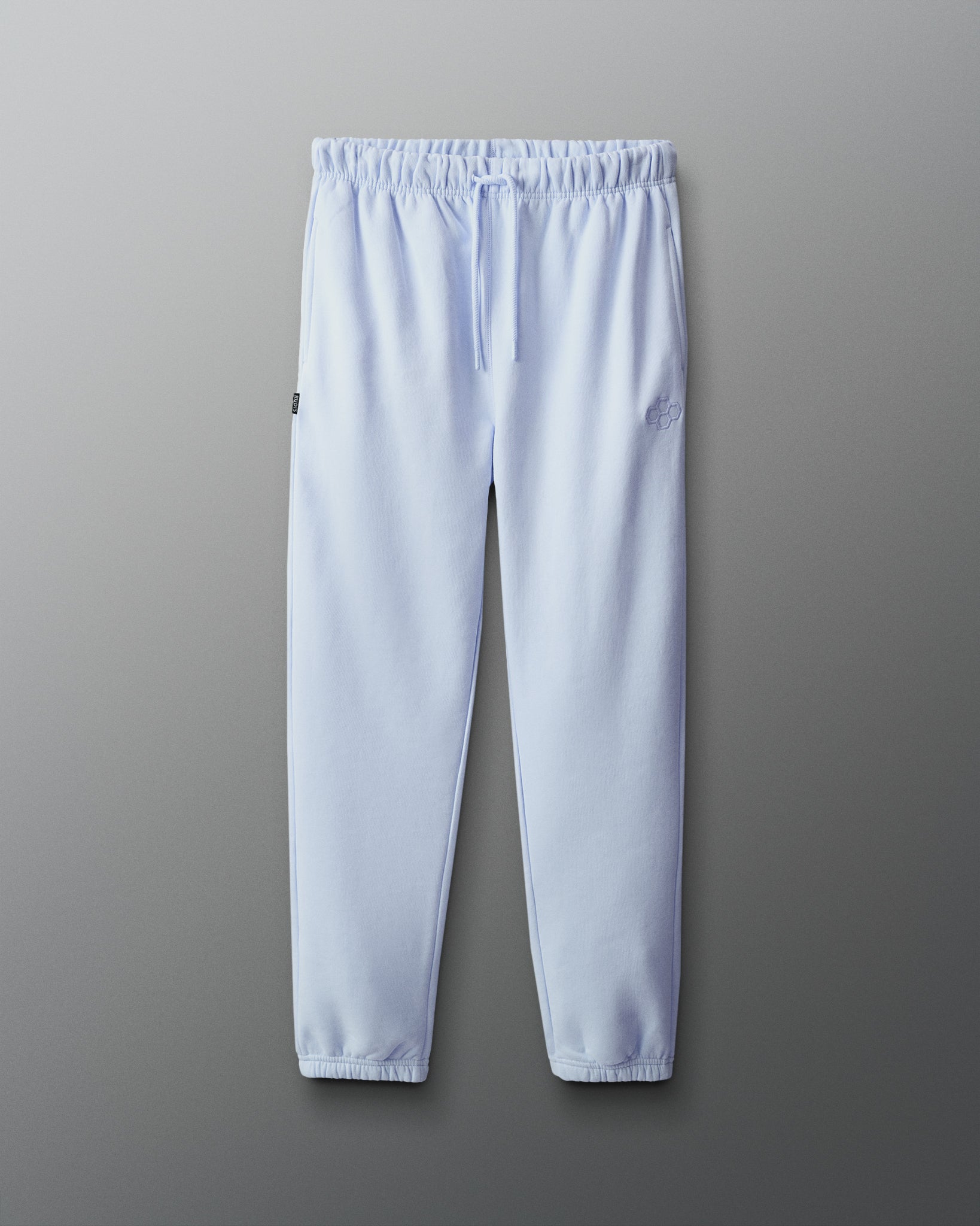 Light blue sweatpants on a gray background