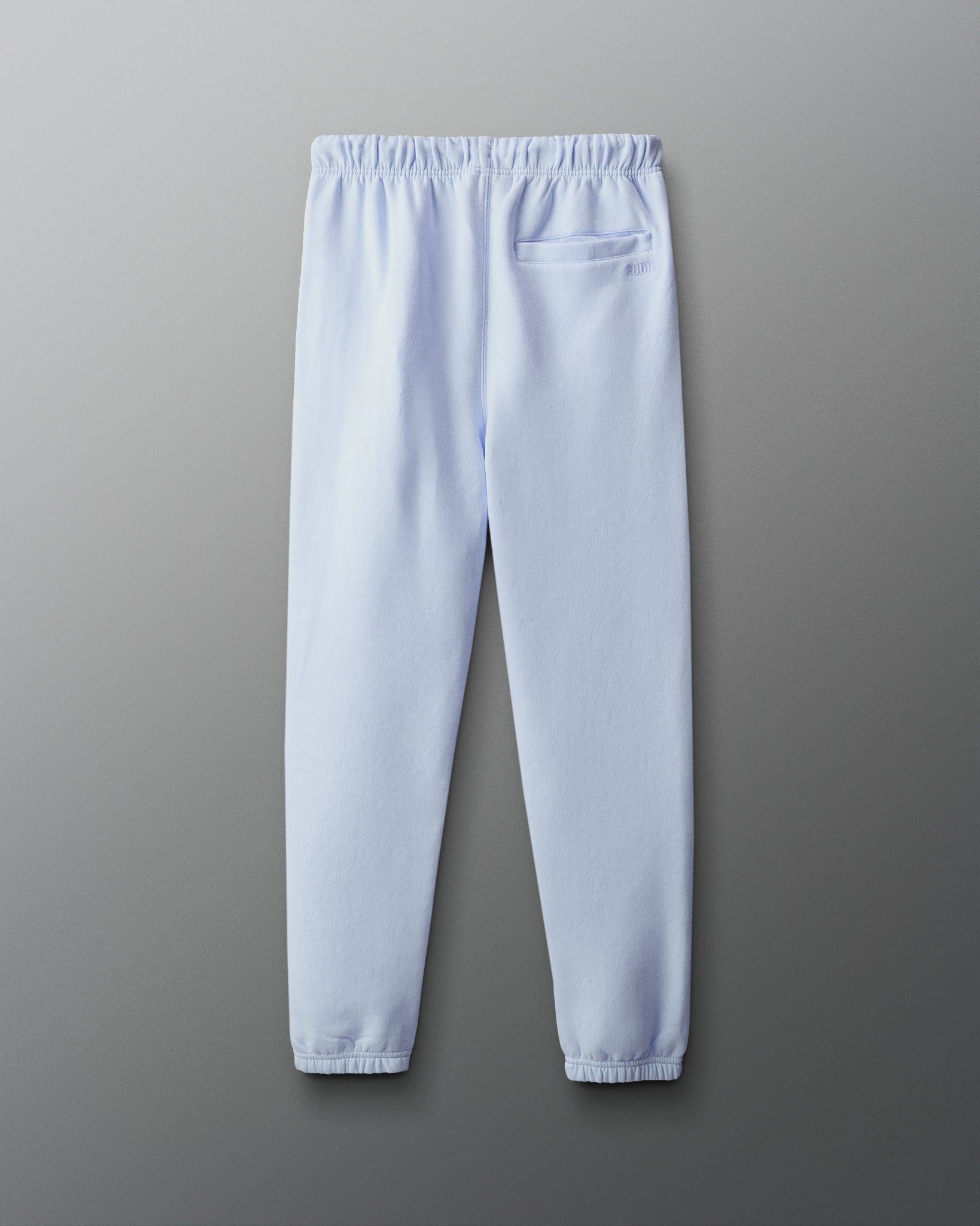 Light blue sweatpants on a gray background