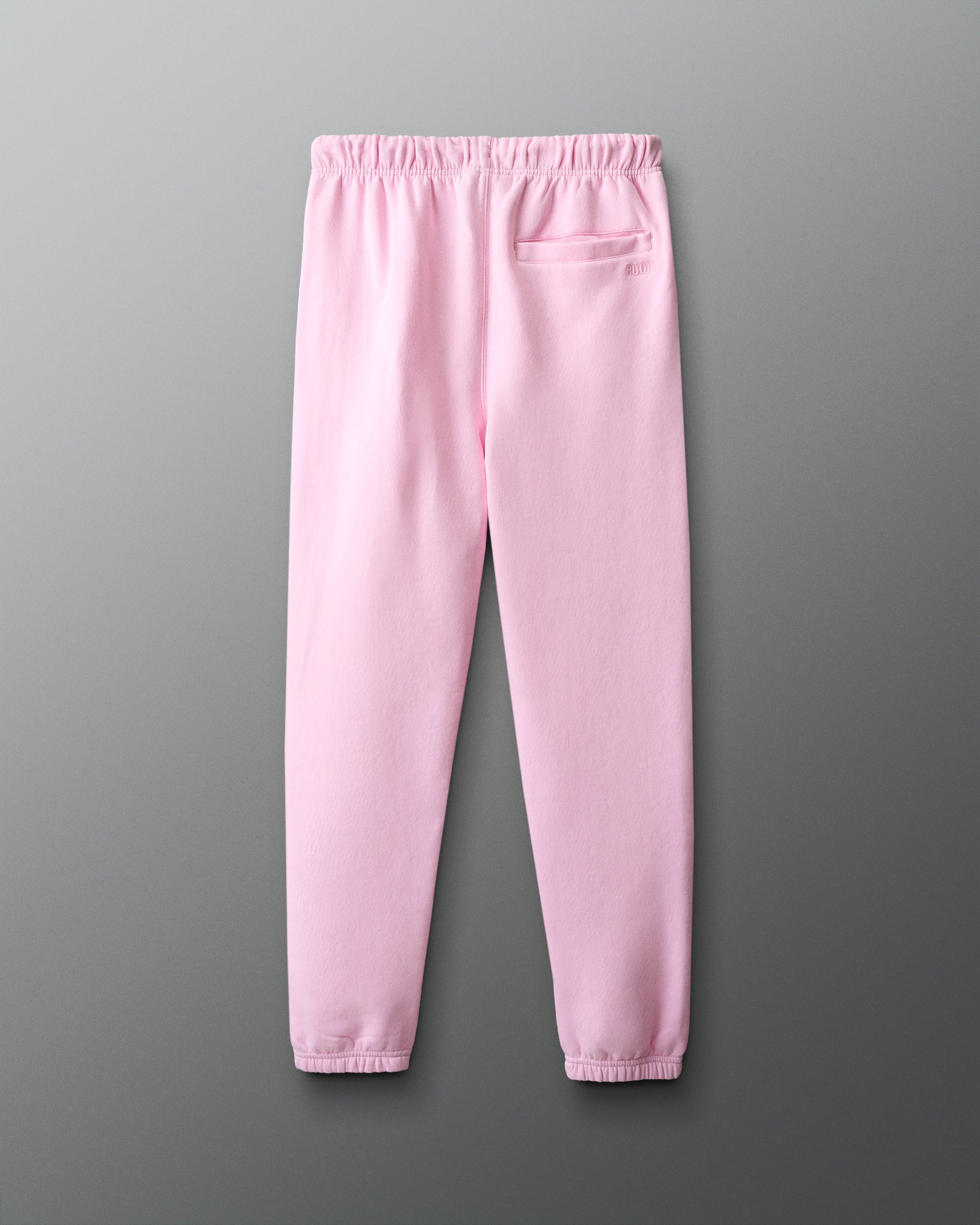 Pink sweatpants on a gray background