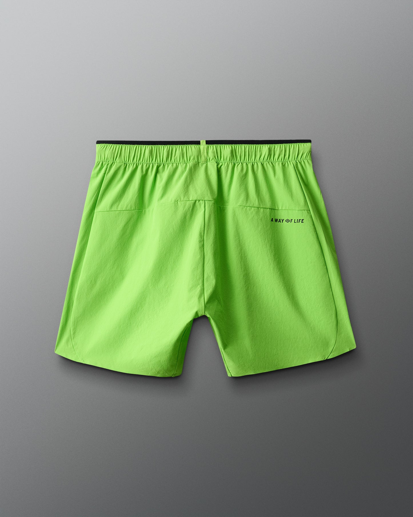 Green shorts with a brand logo on a gray background