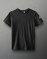 A simple black short-sleeve t-shirt with a crew neckline and a small white logo on the sleeve, set against a gray background.