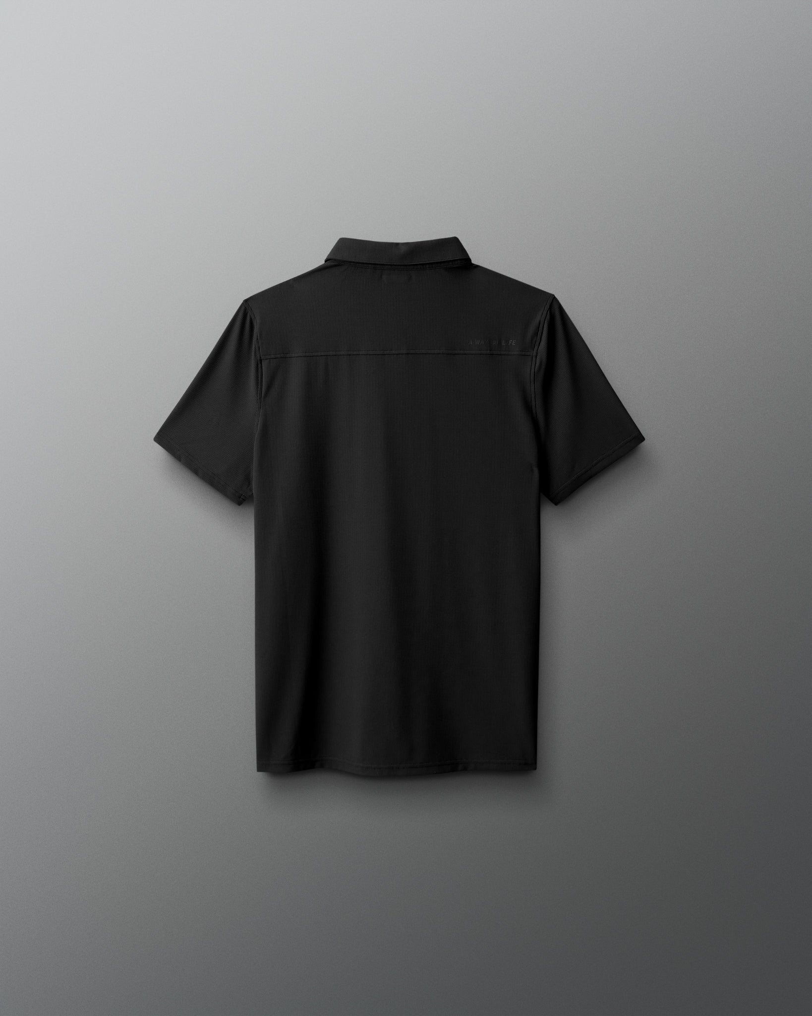 Black short-sleeve shirt on a gray background