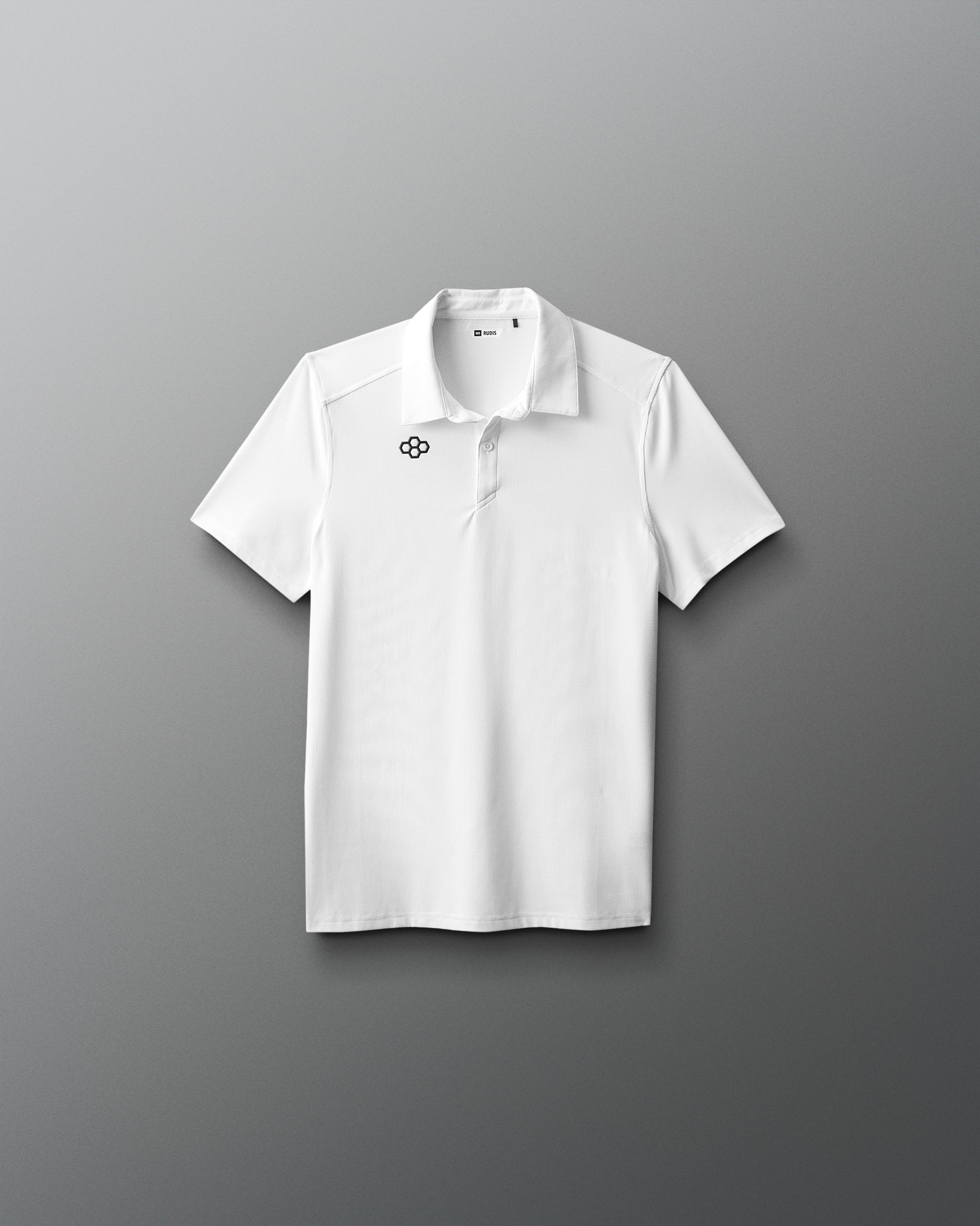 White polo shirt with a logo on a gray background