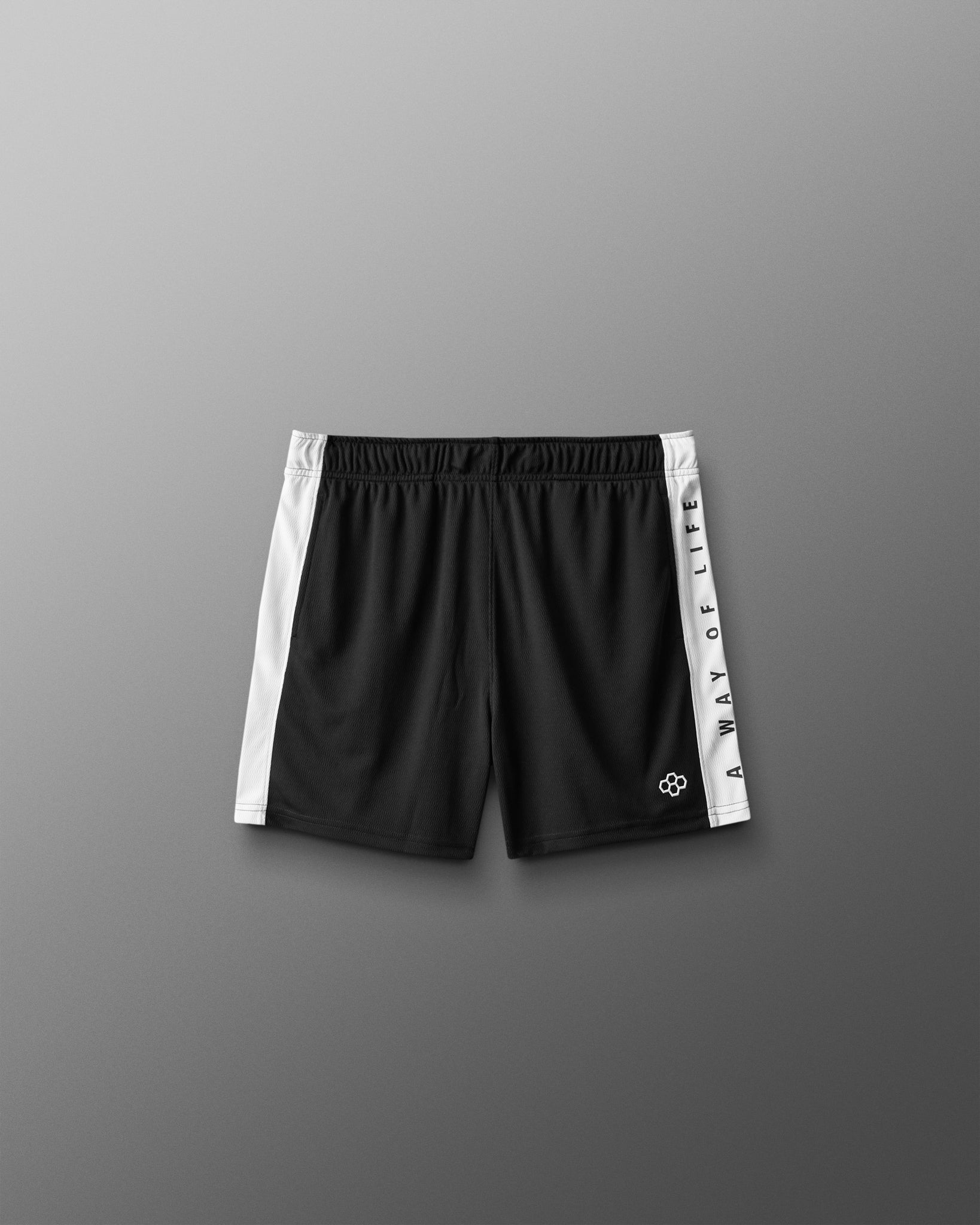Black shorts with white side panels on a gray background