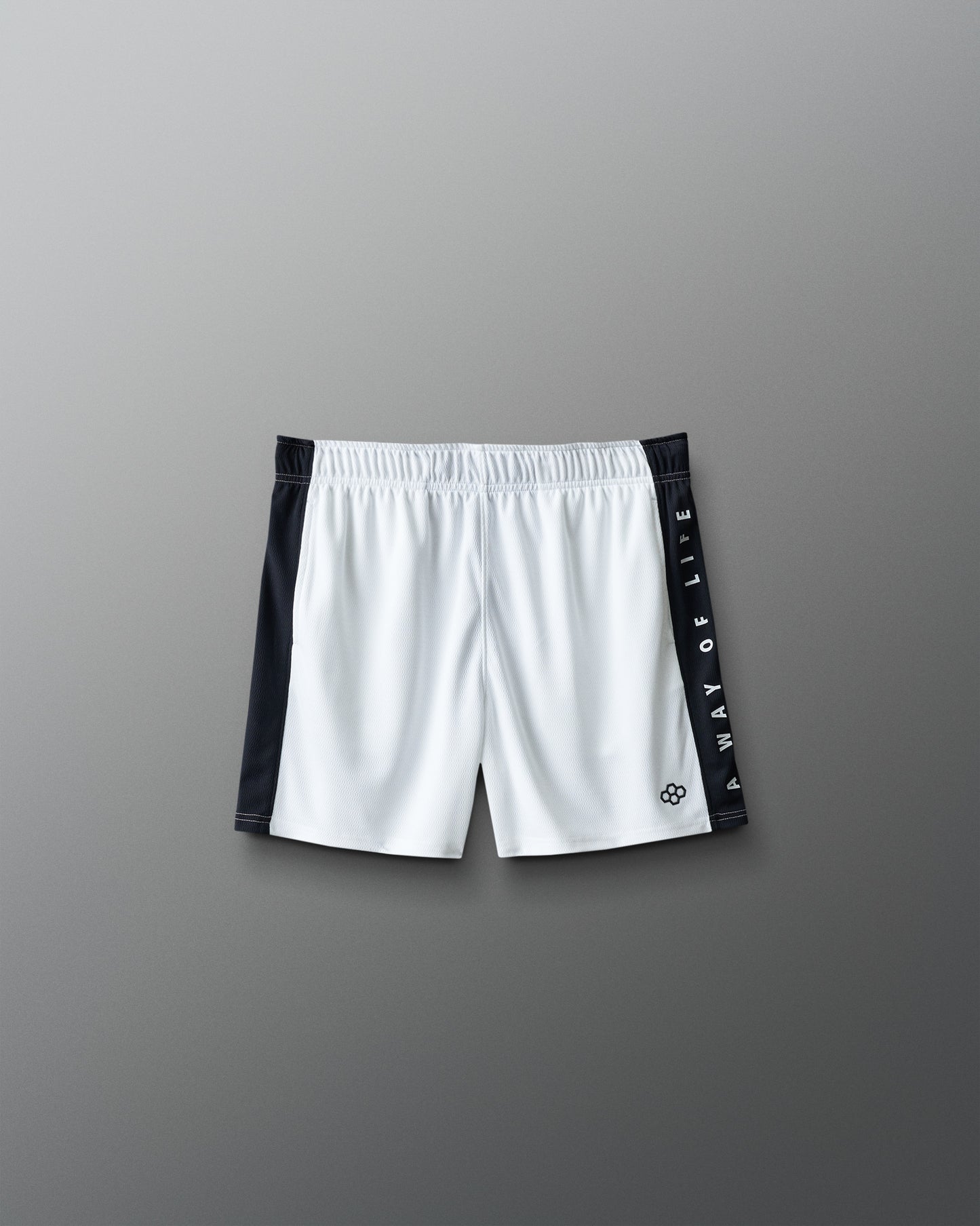 White shorts with black side panels on a gray background