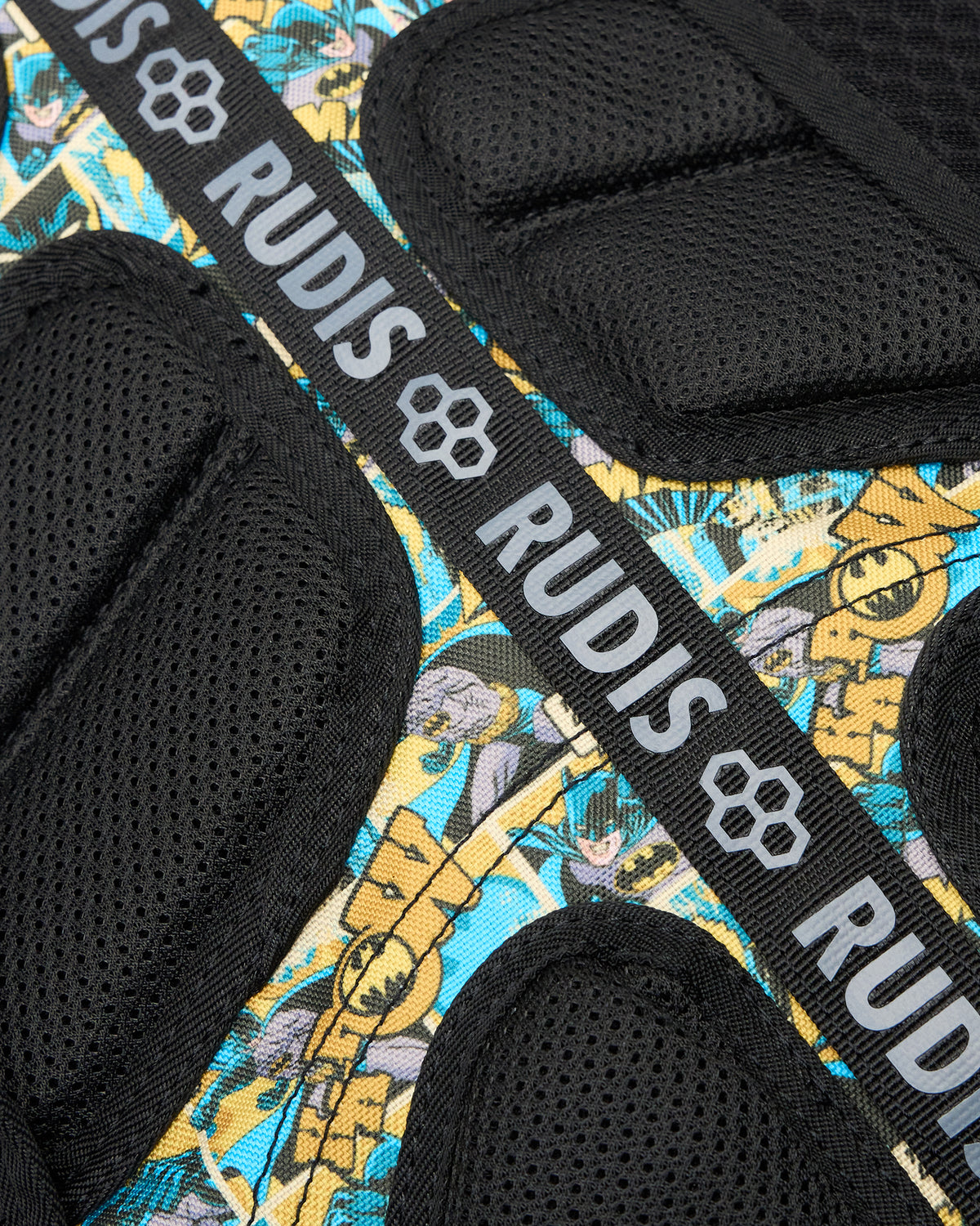 Close-up of the RUDIS Batman Double Cinch backpack back padding, breathable mesh construction, Batman comic print, and branded RUDIS webbing.