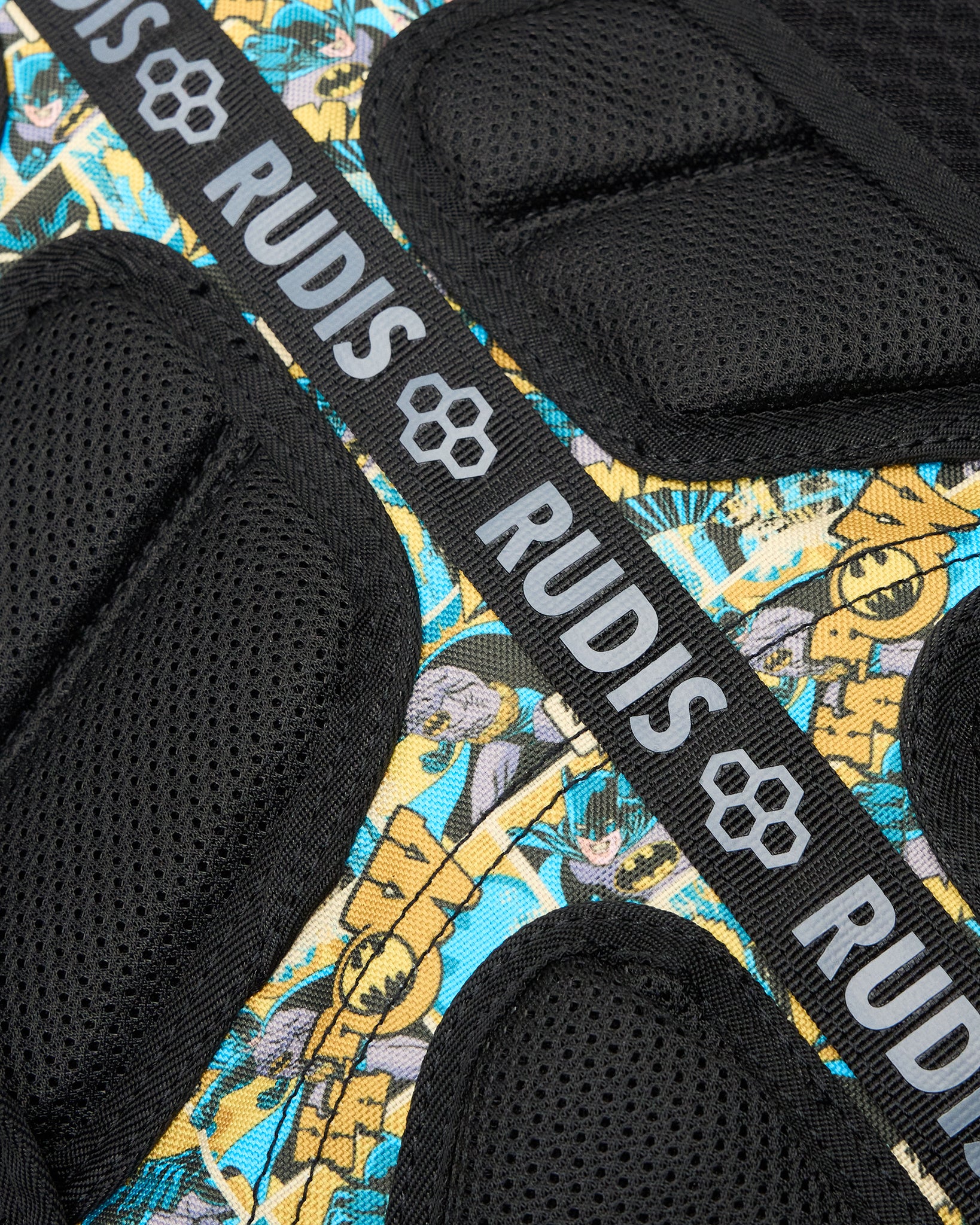 Close-up of the RUDIS Batman Double Cinch backpack back padding, breathable mesh construction, Batman comic print, and branded RUDIS webbing.